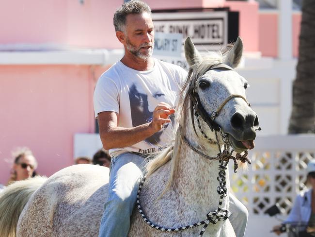 COOLANGATTA , AUSTRALIA -NewsWire photos AUGUST 22, 2021, A man  on a grey horse charges through the  