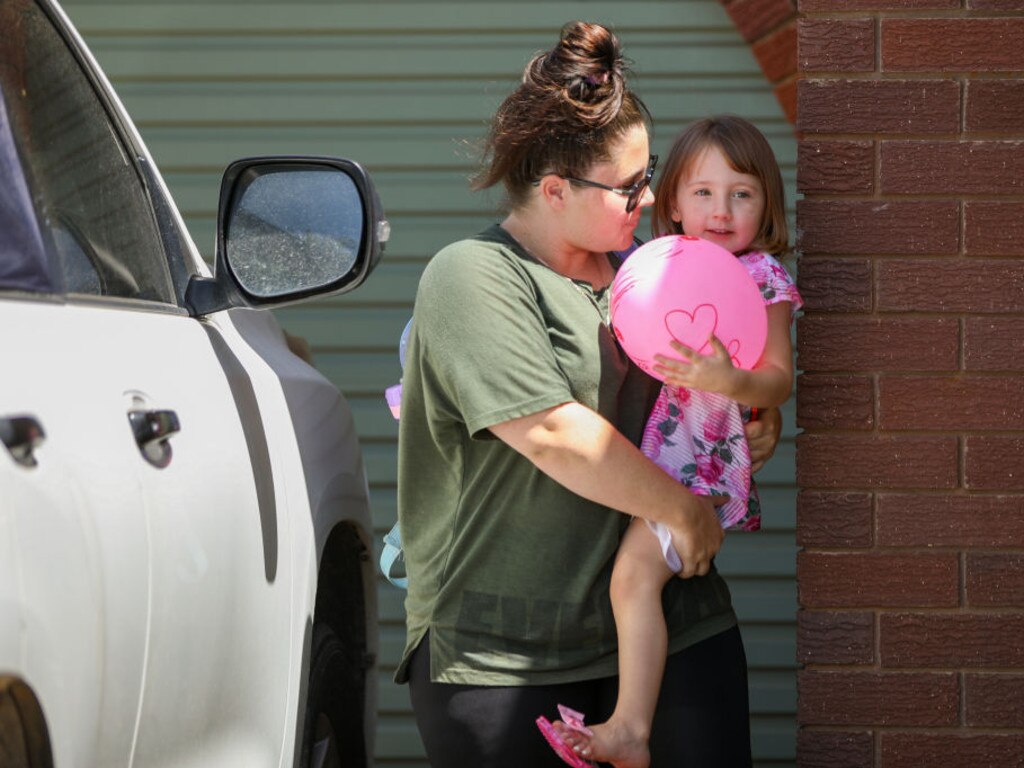 Cleo Smith is carried inside a friend's house by her mother on November 4, 2021 in Carnarvon, Australia.