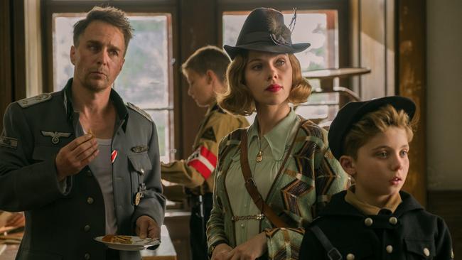 Sam Rockwell, Scarlett Johansson and Roman Griffin Davis in a scene from Jojo Rabbit.