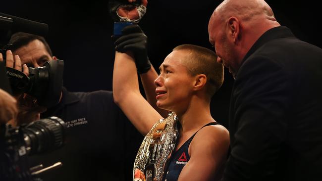 UFC President Dana White awards the new Womens Strawweight UFC title belt Rose Namajunas.