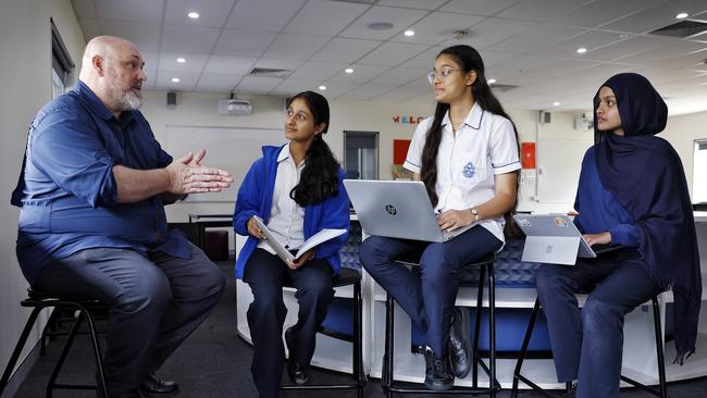 Year 9 and 10 students - (from left) Heli Desai, Janvi Patwal and Inara Ahmed — at Macarthur Girls High School in Parramatta with their head of science Murray Henstock. Picture: Sam Ruttyn