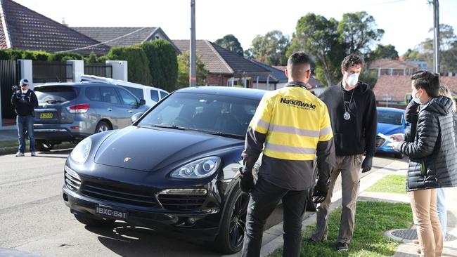 Police raid an Earlwood home using dogs and seizing a Porsche car. Picture: John Grainger