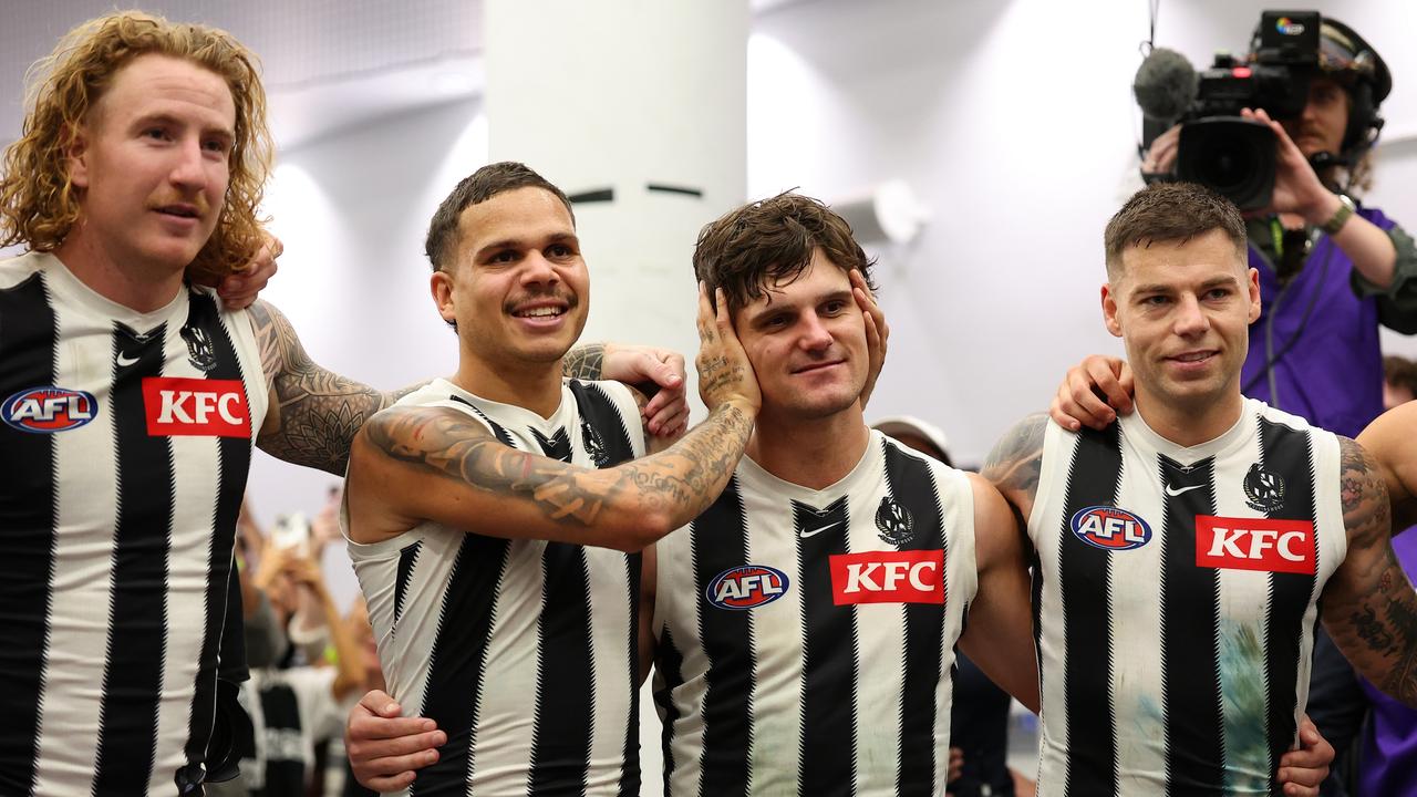 Collingwood players get around Lachie Schultz (third from left) as the club song is sung. (Photo by Paul Kane/Getty Images)