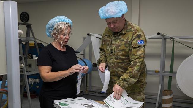 Warrant Officer Robert Freestone and Med-Con employee Jodie Smith label boxes. Picture: Defence