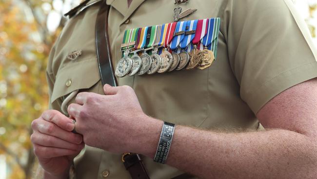 Major Andrew Evans with a commemorative bracelet of Capt Paul McKay Picture: Russell Millard