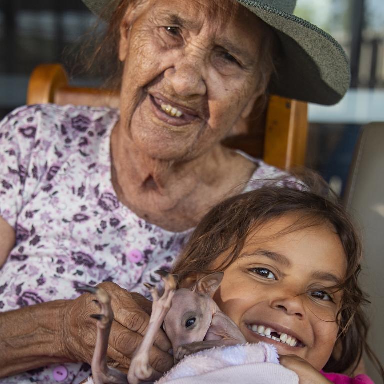 Mornington Island’s oldest resident, Elder Roberta Felton, 90, with two of the youngest: Lilila Yanner, 5, and a days-old joey. Picture: Brian Cassey