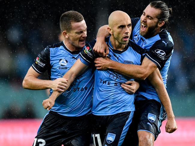 Adrian Mierzejewski (centre) of Sydney reacts after scoring.