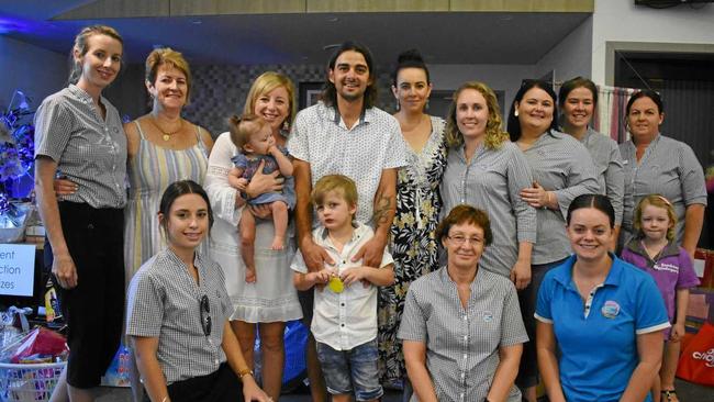 Braxton and his family with the organisers of his auction, the staff from Goodstart Early Learning. Picture: Ebony Graveur