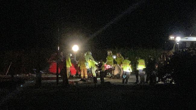 Emergency services at the scene of a fatal crash involving a ute and a truck on the Bruce Highway at Proserpine.