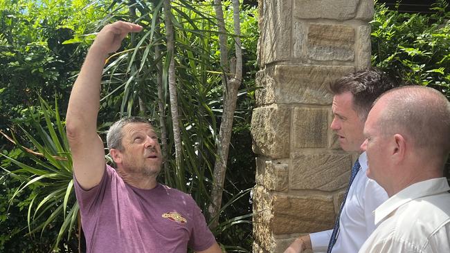 Tumbulgum resident Tony Snellgrove shows Opposition leader Chris Minns and Tweed Labor candidate Craig Elliot how high the water reached in the 2022 flood. Picture: David Bonaddio