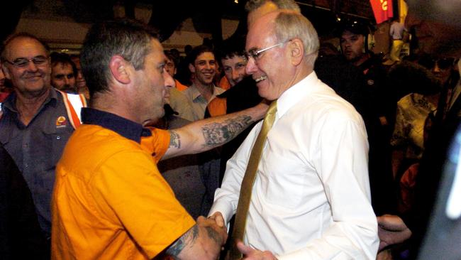 John Howard greets a forestry worker after announcing his Tasmanian forestry policy in Launceston in 2004. Picture: AAP Image/Alan Porritt