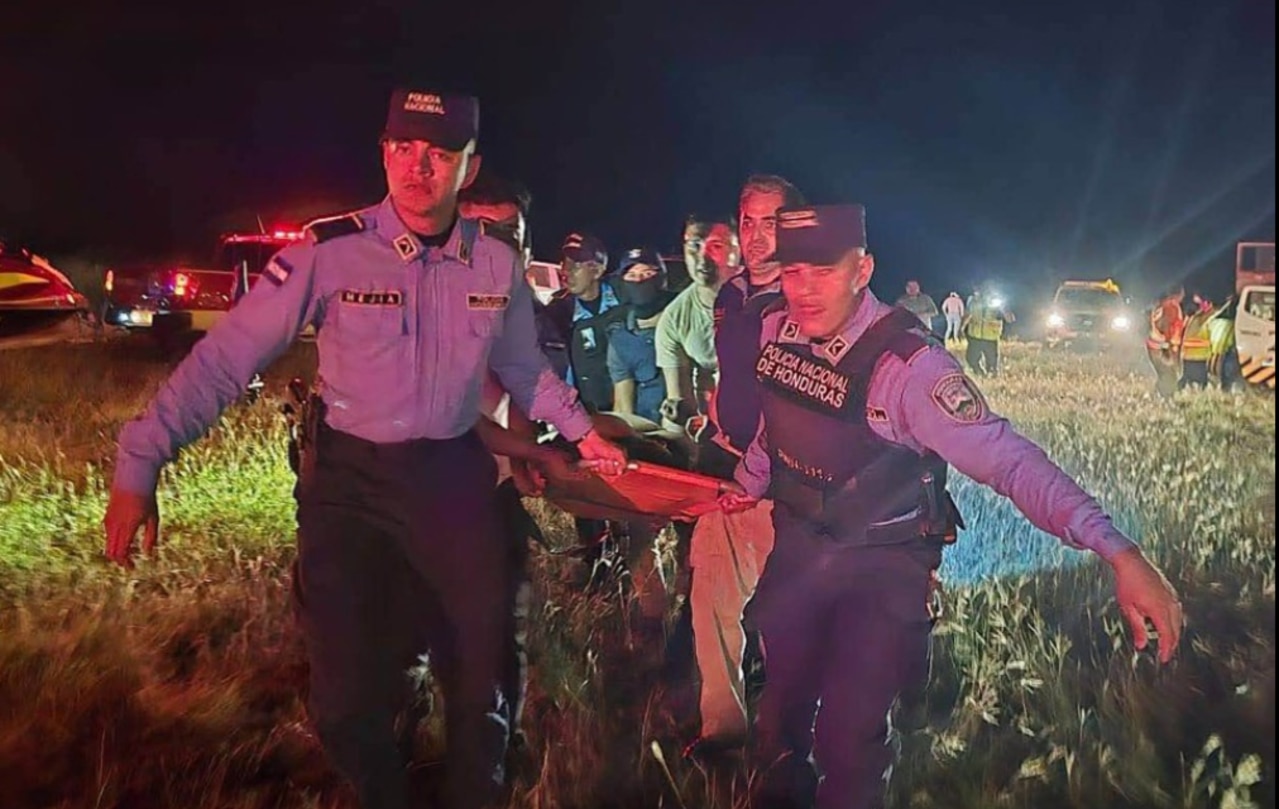 Honduran rescue teams carrying an injured man after a plane crash. Picture: AFP