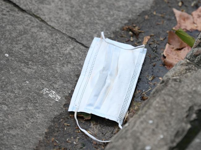 ADELAIDE, AUSTRALIA - NewsWire Photos AUGUST 2, 2021: A mask in the gutter on Gouger Street. Picture: NCA NewsWire / Naomi Jellicoe