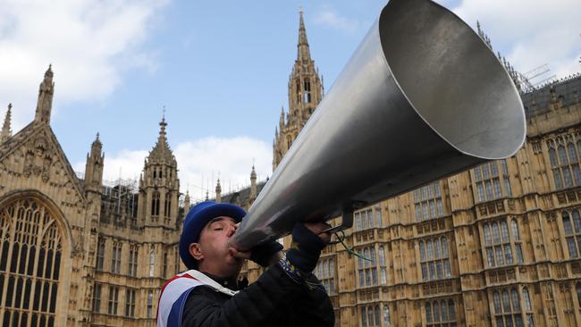 A pro-EU protester shouts at the Houses of Parliament in London on Wednesday. Picture: AP