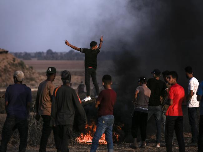 Palestinian protesters gather near the fence of the Gaza Strip border with Israel during a protest east of Khan Younis, southern Gaza Strip on August 25. Picture: Getty