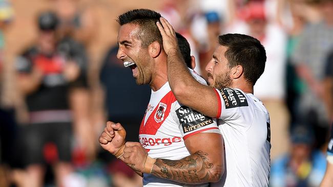 Paul Vaughan celebrates scoring a try for the Dragons.