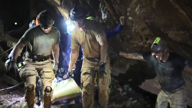 Rescue personnel carry a child from the Tham Luang cave in Khun Nam Nang Non Forest Par. Picture: File