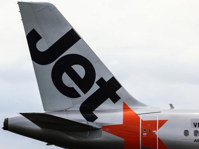 SYDNEY, AUSTRALIA - JANUARY 20: The Jetstar logo displayed on an aircraft tail at Sydney Airport  on January 20, 2024 in Sydney, Australia. Transport Minister Catherine King signed off on a deal that will allow Turkish Airlines to start serving the Australian market, rising to 35 flights a week by 2025. The decision came as the government was under mounting criticism from many for a perception that it was protecting the profits of Qantas and stymying competition in the market by limiting additional capacity for other carriers, such as Qatar Airways. (Photo by Jenny Evans/Getty Images)