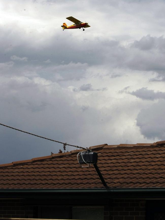 A plane flies overhead in Scarlet St, Mordialloc.