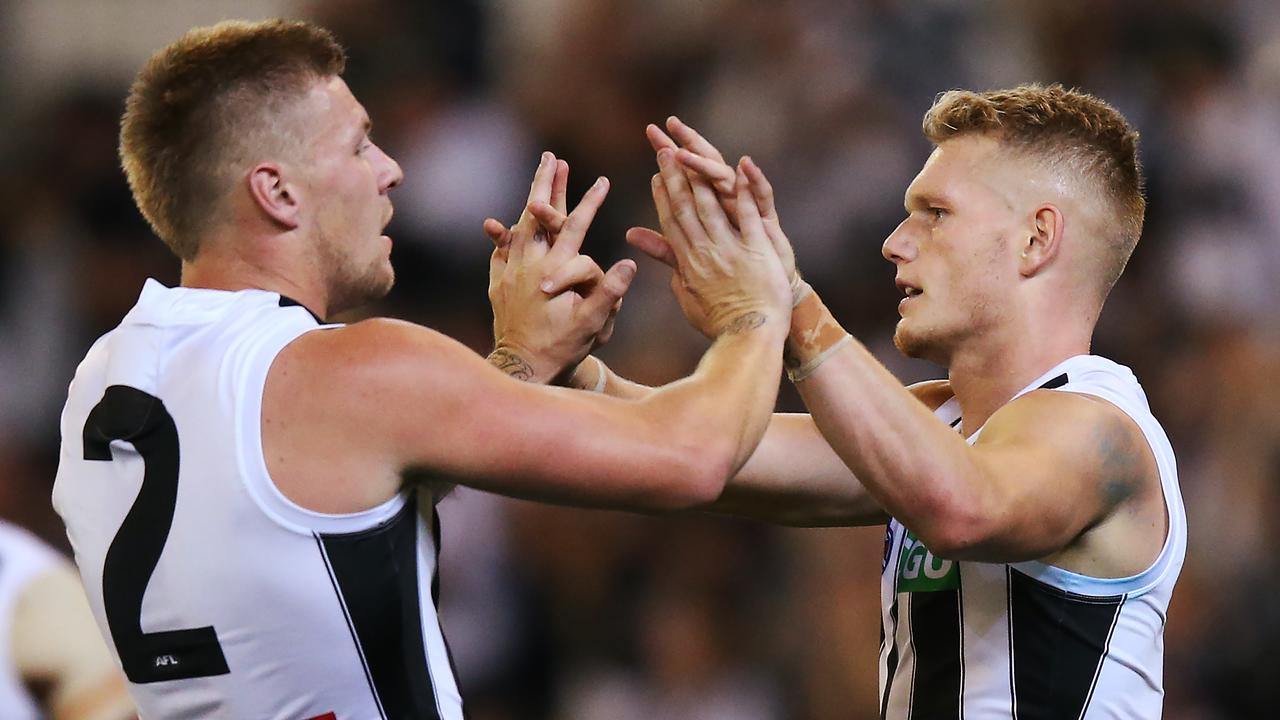 Adam Treloar and Jordan De Goey celebrate a goal.