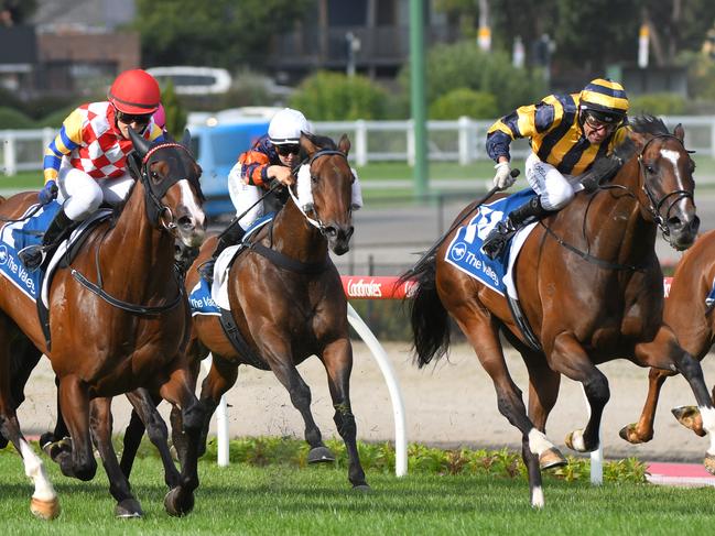 Dwayne Dunn pushes out Exquisite Beauty (right) to a win in the New Years At Legends Handicap.