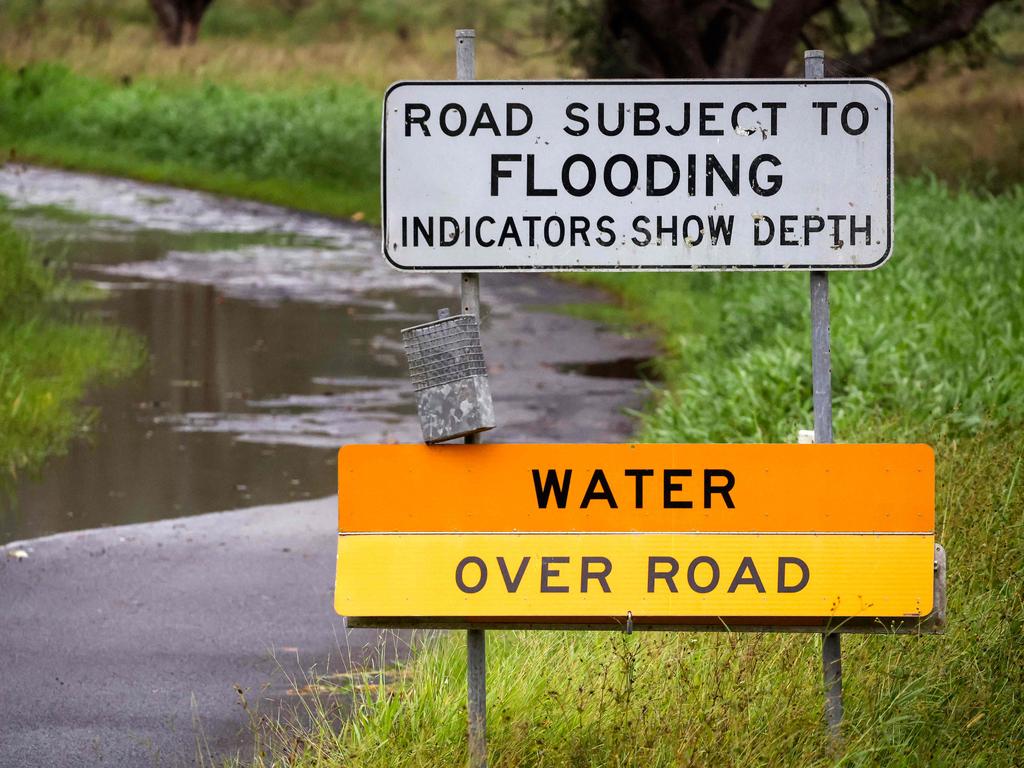 A warning sign in front of a flooded road can be seen on the outskirts of the coastal town of Ballina, NSW. Picture: David Gray/AFP