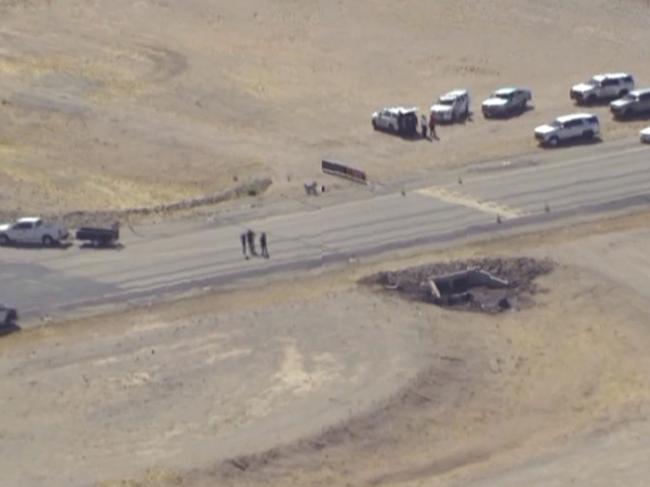 In this image taken from video, law enforcement at the site of a deadly plane crash at Marana Regional Airport after a deadly crash in Marana, Ariz., Wednesday, Feb 19, 2025. (KNXV via AP)