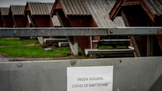 A sign in Danish language reads “No access, risk of COVID-19 infection” at a mink farm in Hjorring, in North Jutland, Denmark. Picture: AFP