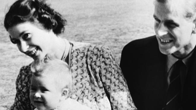 Eight-month-old Prince Charles, foreground left, with then-Princess Elizabeth of England, left, and his father Philip. Picture: AP