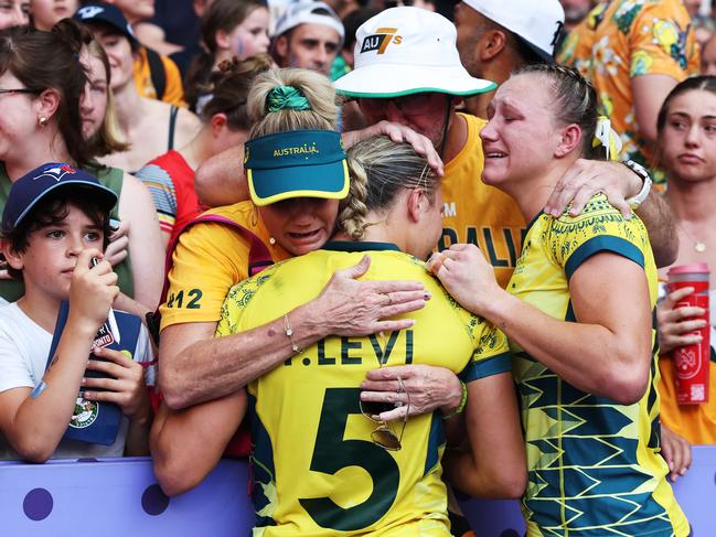 Teagan and Maddison Levi are comforted after their loss in the bronze medal playoff. Pcture: Cameron Spencer/Getty Images