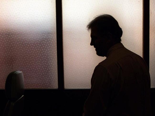 Generic image. Silhouette of a man (parent of) a sex abuse victim in an office. wrongly accused of touching young girl. Child sexual abuse. sex crime incest paedophilia.