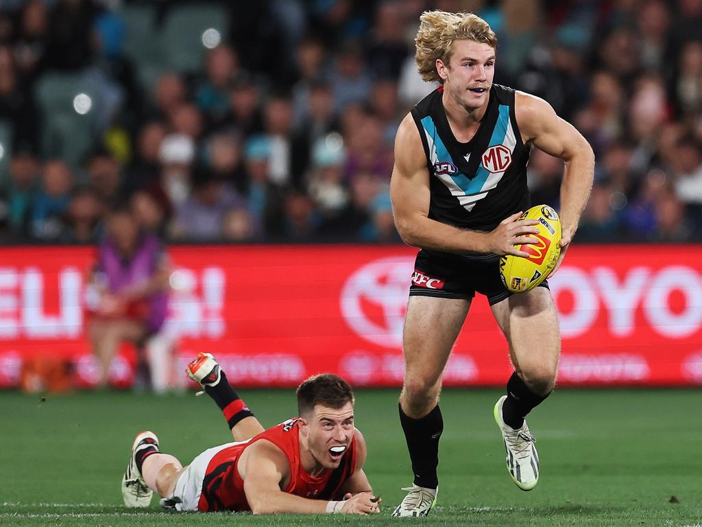 Jason Horne-Francis leaves Zach Merrett in the dust on Friday night. Picture: James Elsby/AFL Photos via Getty Images.