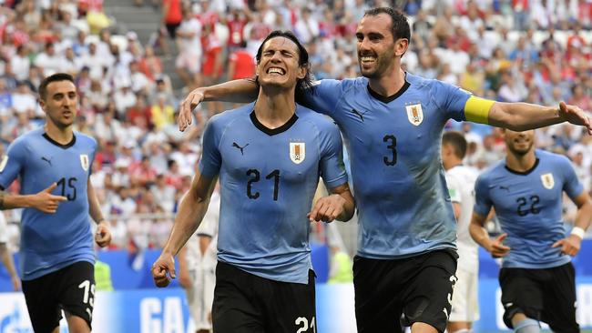 Uruguay's Edinson Cavani, centre, celebrates. (AP Photo/Martin Meissner)