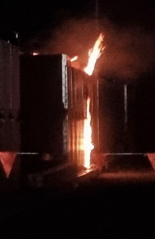 A fire rages in a battery storage bank at a power sub-station at Bouldercombe near Rockhampton.