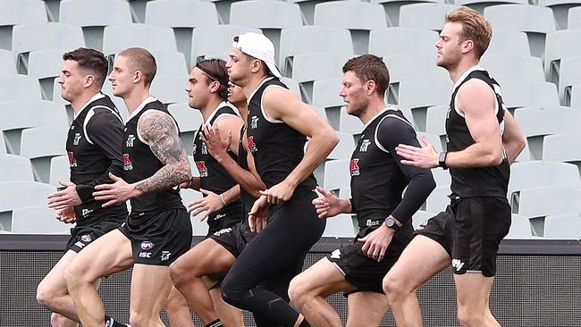 Tom Rockliff, left, leads a Power running group at training.