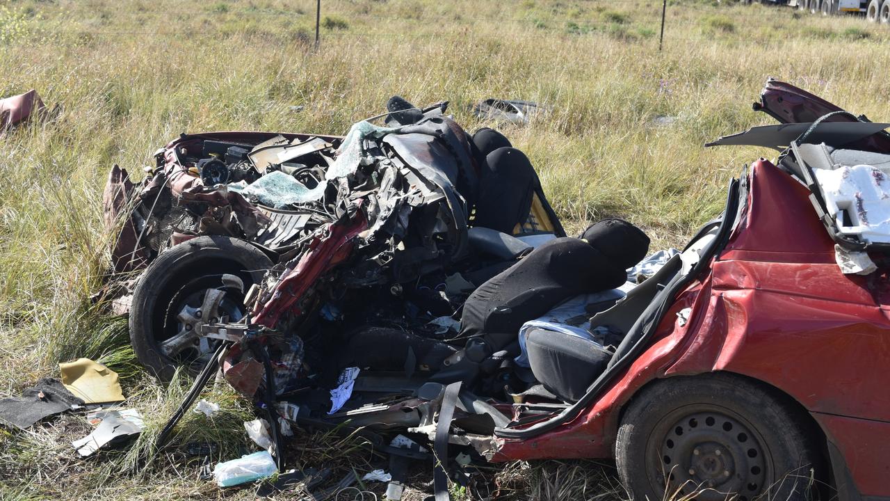 TANGLED MESS OF METAL: The Holden Commodore was barely recognisable after crashing into a truck on the Warrego Highway at Bowenville on Friday. June 18. Picture: Sam Turner