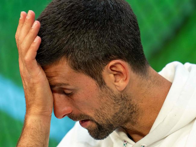 TOPSHOT - Serbia's Novak Djokovic reacts as he speaks during a press conference in the Media Theatre at the Broadcast Centre following his defeat in the men's singles final tennis match against Spain's Carlos Alcaraz on the last day of the 2023 Wimbledon Championships at The All England Tennis Club in Wimbledon, southwest London, on July 16, 2023. (Photo by Joe TOTH / various sources / AFP) / RESTRICTED TO EDITORIAL USE