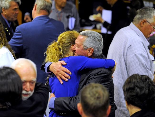 Councillor Charlie Pisasale (centre) embraces a colleague at yesterday’s final meeting of Ipswich City Council before it is dissolved. Picture: John Gass/AAP