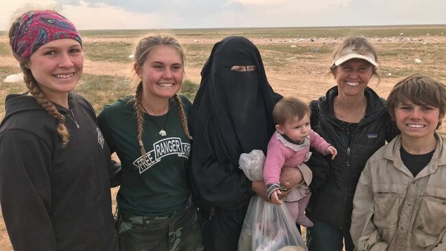 Zehra Duman - holding her daughter - with aid workers from the Free Burma Rangers in Baghouz in Syria in March 2019.