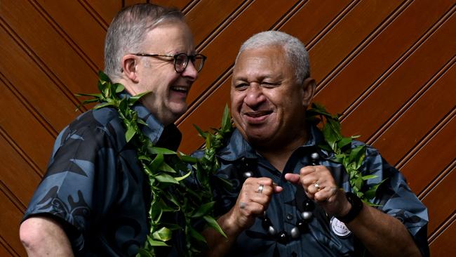 Prime Minister Anthony Albanese shares a lighter moment with Fiji PM Frank Bainimarama during the family photo at the Pacific Islands Forum (PIF) in Suva on July 14.