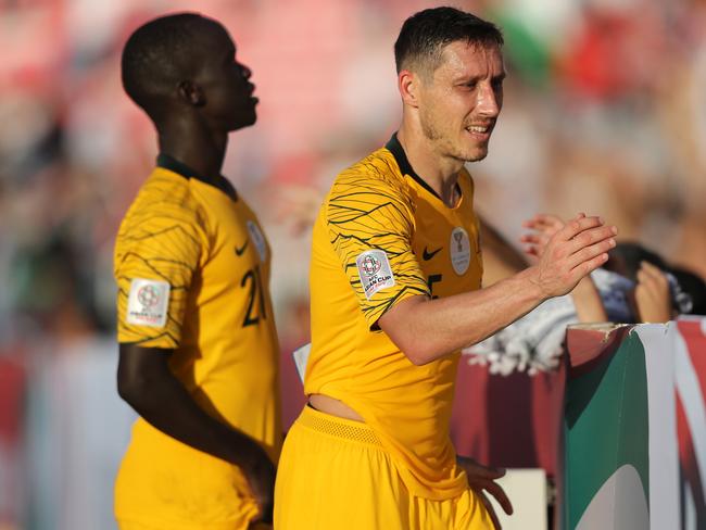 DUBAI, UNITED ARAB EMIRATES - JANUARY 11:  Mark Milligan of Australia and Awer Mabil of Australia acknowledges the crowd following their sides victory in the AFC Asian Cup Group B match between Palestine and Australia at Rashid Stadium on January 11, 2019 in Dubai, United Arab Emirates. (Photo by Francois Nel/Getty Images)