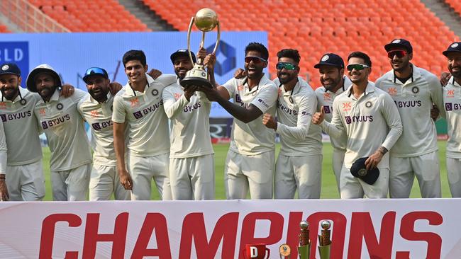 India’s players pose with the Border-Gavaskar Trophy after beating Australia in their latest Test series in March.