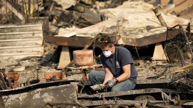 Kevin Marshall sifts through his mother’s fire-ravaged property in the the Palisades Fire in the Pacific Palisades neighbourhood. AP Photo