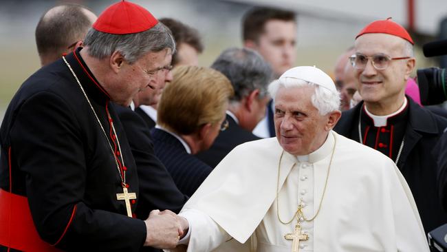 Pope Benedict XVI is greeted by Cardinal George Pell left, upon his arrival in Sydney in 2008. (Pic: Mark Baker/AP)