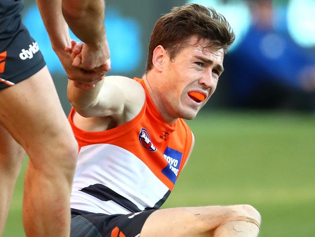 SYDNEY, AUSTRALIA - JULY 29: Stephen Coniglio of the Giants assists team mate Jeremy Cameron during the round 19 AFL match between the Greater Western Sydney Giants and the Fremantle Dockers at Spotless Stadium on July 29, 2017 in Sydney, Australia.  (Photo by Cameron Spencer/Getty Images)