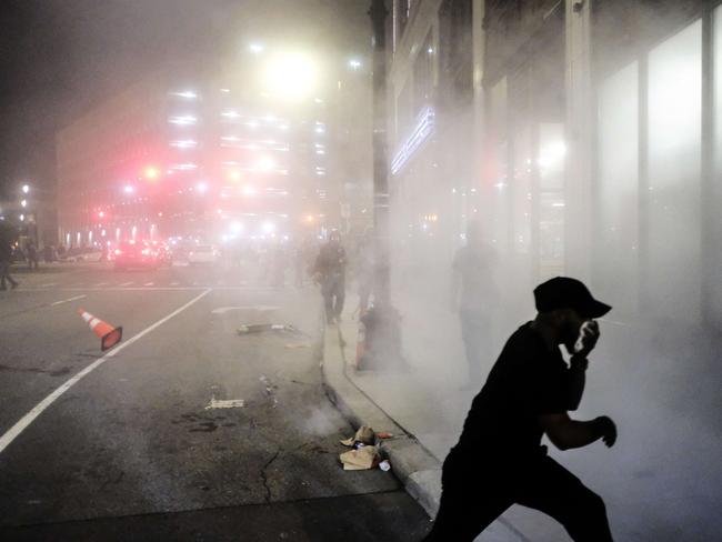 \A protester scrambles to escape a cloud of tear gas in Detroit, Michigan. Picture: Getty