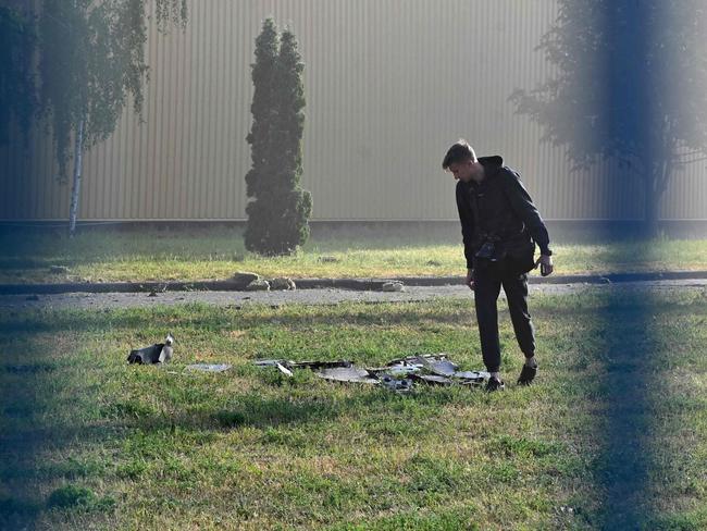 An expert examines remains of a drone in an industrial facility after a massive Russian drones strike mainly targeting the Ukrainian capital, in Kyiv. Picture: AFP