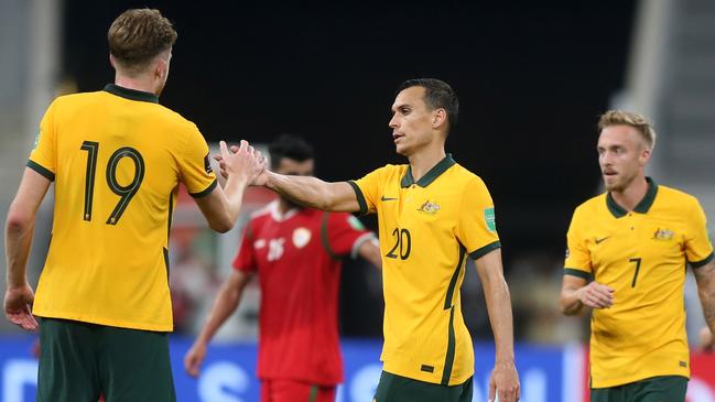 DOHA, QATAR - OCTOBER 07: Australia's players celebrate their win in the 2022 FIFA World Cup Qualifier match between Australia and Oman at Khalifa International Stadium on October 7, 2021 in Doha, Qatar. (Photo by Mohamed Farag/Getty Images)