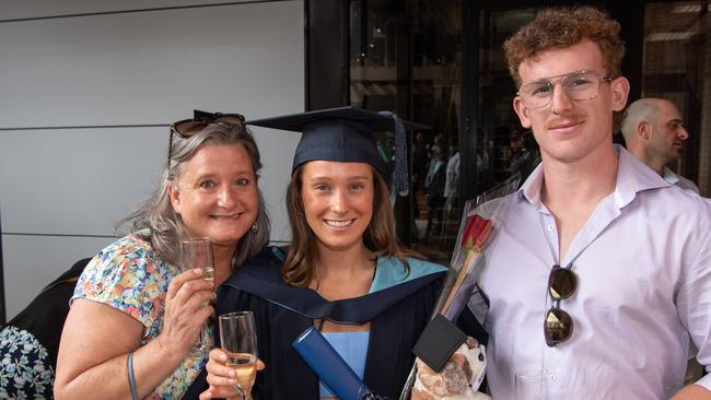 Christina and Faith Holloway with Luke Spiden celebrate graduation. Picture: Brad Fleet