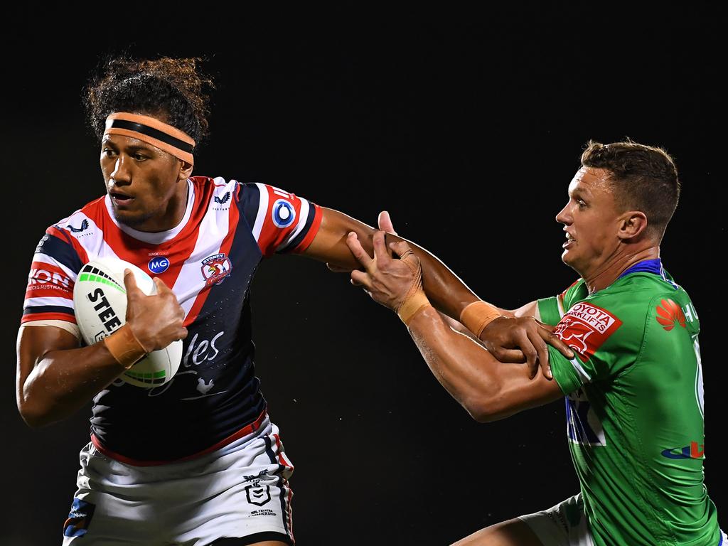 Sitili Tupouniua of the Roosters fends off the tackle from Jack Wighton of the Raiders during the round 25 NRL match between the Canberra Raiders and the Sydney Roosters at BB Print Stadium, on September 02, 2021, in Mackay, Australia. Picture: Albert Perez